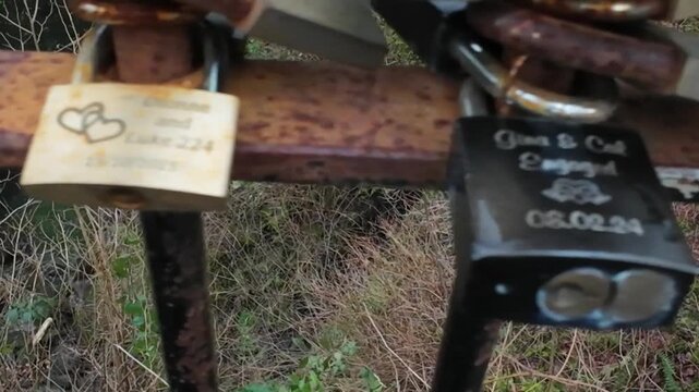 Rusty love locks padlocks on an iron fence