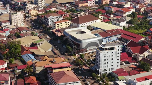 Urban landscape showing city buildings, street intersection and traffic in downtown Vientiane, Laos from a fixed top down shot