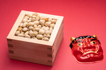 Soybeans for Setsubun festival with red demon mask