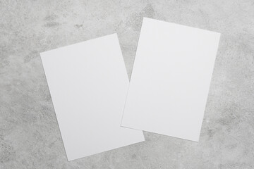 Two blank white cards on grey concrete background, ideal for greeting cards, wedding invitation or...