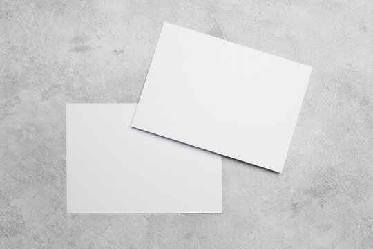 Two white blank cards mockup on grey background, copy space for greeting card, wedding invitation or flyer design presentation