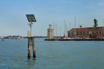 The bricole is distinctive landscapes details of the Venetian Lagoon that guide boats through it calm waters. Venice, Italy.