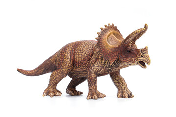 Triceratops dinosaur hard plastic toy isolated on white background. © Panupong