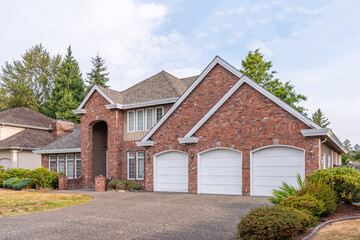 Obraz premium Two story luxury house with beautiful summer landscape in Vancouver, Canada, North America. Day time on August 2025.