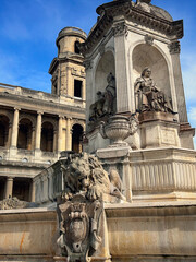 Monumental the Fontaine Saint-Sulpice and the Church of Saint-Sulpice against the blue sky in the 6th arrondissement of Paris, France. 