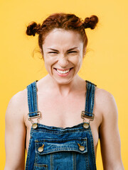 Sexy redhead wearing overalls laughing