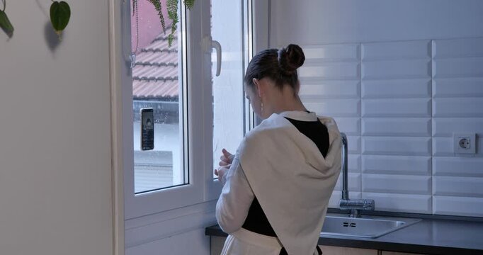 Close-up of hands carefully adjusting a white scarf over the shoulders, completing the traditional costume for Christmas festivities.