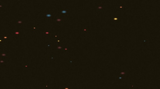 Dark canvas dotted with multicolored speckles forms a tranquil, starry nightscape of tinyish lights