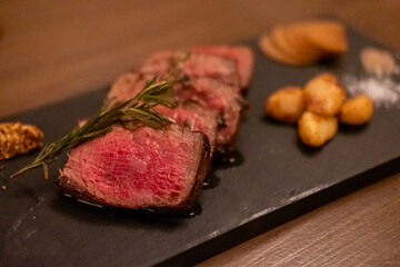 Sliced medium rare Wagyu beef on plate