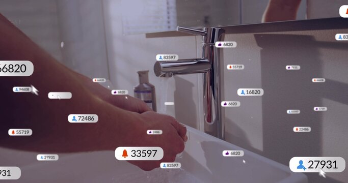 Washing hands at bathroom sink under chrome faucet with soap running water floating tags and cursor