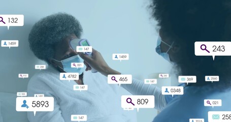 Measuring masked caregiver taking senior in robe temp with thermometer in clinic amid digital UI