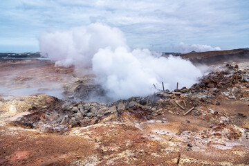 Gunnuhver active geothermal area with bubbling mud pools, fumaroles, hiking trails, and raised viewing platforms on the Reykjanes Peninsula during a day in March.
