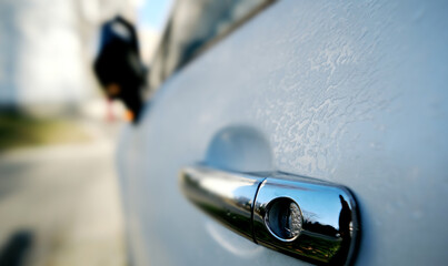 Car Driver Door Handle of Frost-Covered Car On Parking In Morning Light