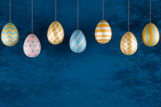Colorful hanging easter eggs with striped and dotted patterns on blue background. 3d rendering