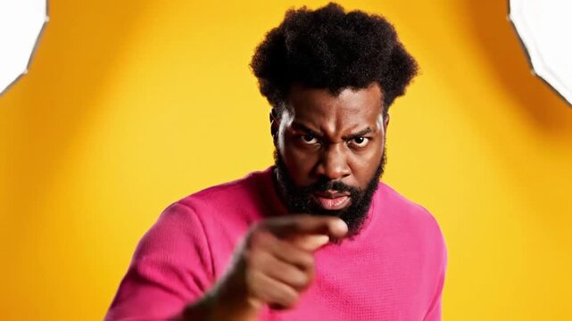 Man pointing aggressively in pink sweater