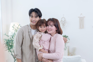 Asian family enjoys spending their time together in a living room