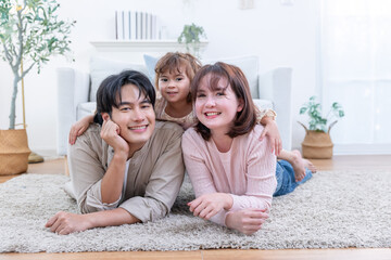 Asian family enjoys spending their time together in a living room