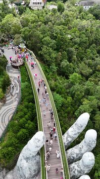 Aerial View of Golden Bridge Cau Vang Held by Giant Hands in Ba Na Hills Da Nang Vietnam at Sunrise
