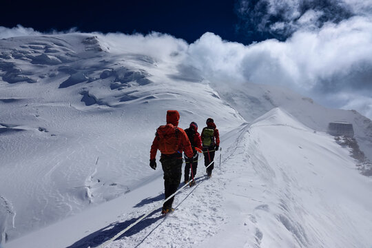 Climbers traversing the Go&ucirc;ter Ridge toward the Go&ucirc;ter Hut Mont Blanc massif France