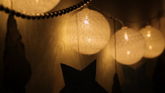 The round garland lights up at night. Warm light bulbs create a cozy atmosphere. Decorations for a cozy home.