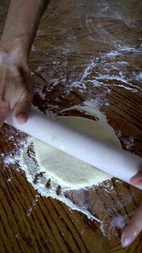 Start rolling. Place the dough ball on the floured surface. Using a rolling pin, begin rolling from the centre outwards. Apply even, gentle pressure to maintain a consistent thickness. Roll in all dir