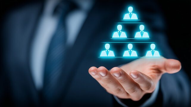Hand presenting organizational hierarchy icons symbolizing leadership structure and workforce management.
