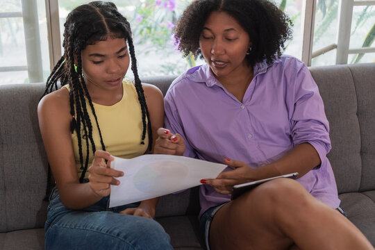 Black women students learning together studying paperwork