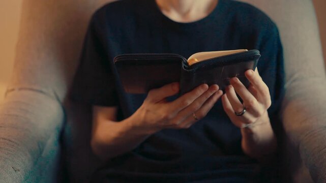 Hands holding Bible reading holy scripture close up 