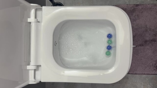 Hygienic toilet cleaning in the modern bathroom. Cleaning balls that foam with water when the flush is pressed, for a refreshing clean.