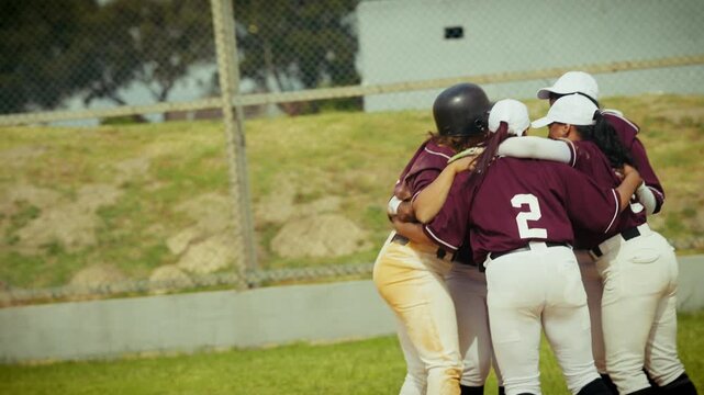 Baseball players celebrate victory in a joyful team huddle