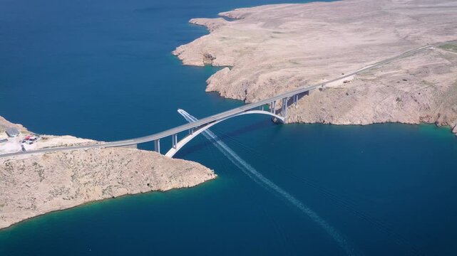Curved bridge over sea near Pag aerial view