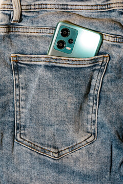 Smartphone in denim pocket showcasing technology and fashion
