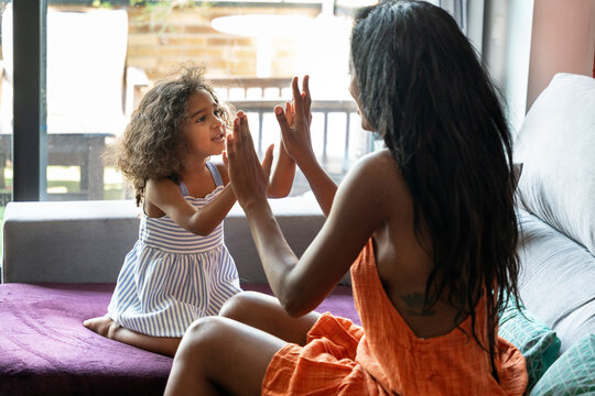 Mother and daughter enjoying playful moments at home