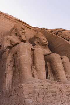 Ancient Egyptian statues of Abu Simbel in desert landscape