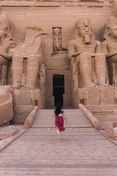 Woman exploring ancient Egyptian temple in the desert