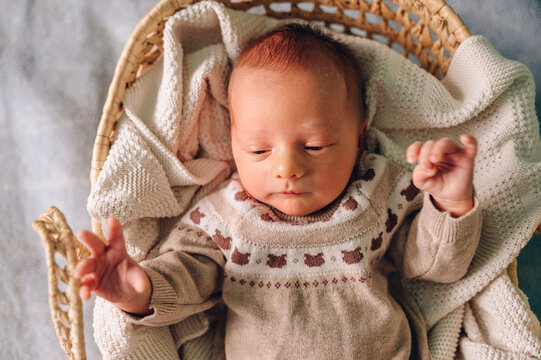 Peaceful newborn resting in a cozy basket