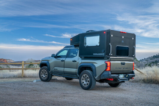 Fort Collins, CO, USA - January 11, 2026: Moonlander camper by Radica on Toyota Tacoma Trailhunter hybrid truck in Lory State Park.