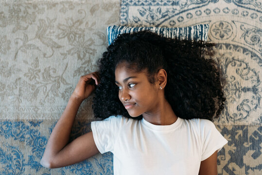 Young girl relaxing on a decorative rug