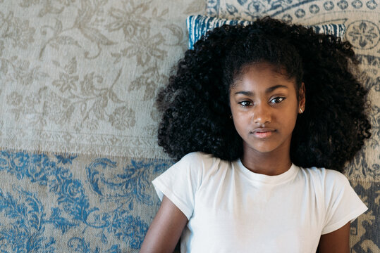 Young girl relaxing on a decorative rug