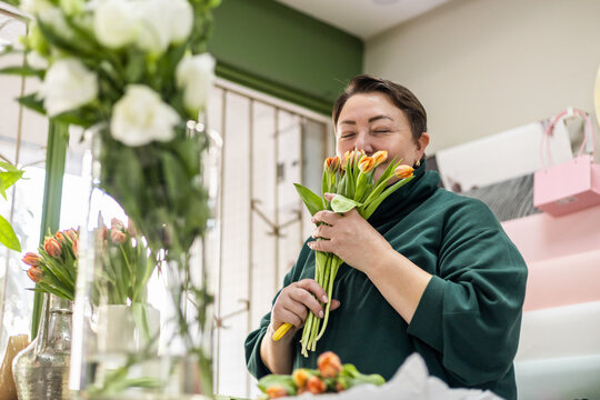 Florist enjoying mini tulips in flower shop
