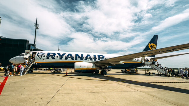 Leeds, UK - 21 July 2025: A Ryanair passenger aircraft parked on the airport apron at Leeds Bradford Airport in the UK, with passengers boarding the plane, illustrating low-cost air travel in Europe.