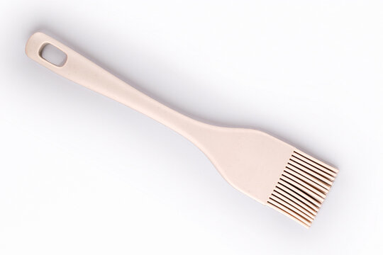 Silicone pastry brush on a white background, close-up, top view.