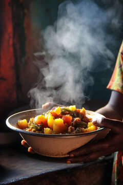 A close-up of "Katogo" (a breakfast mix of matooke and other ingredients), steaming in a bowl, a hearty and popular morning meal.