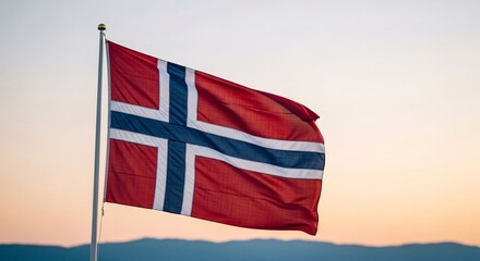 Norwegian flag waving in clear sky at sunset with copy space for branding