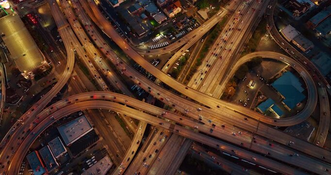 Huge lively interchange with hectic traffic. Top view on the busy intersection in the evening.