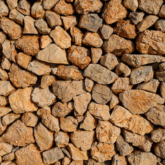 Detail of a dry stone wall as an abstract texture. Natural stones composing an interlocking boundary wall.