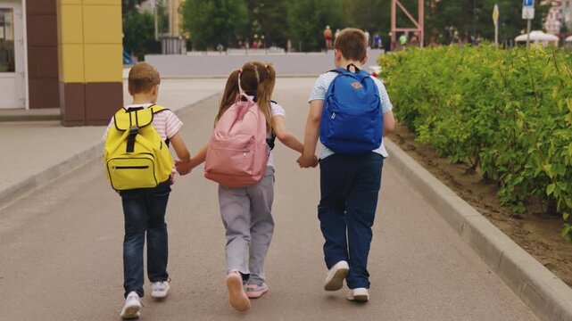 School Time Excitement, Primary Schoolers Walking in a Row, Cute Little Students Heading to Class, Kids Exploring the School Neighborhood, Colorful Backpacks in the Morning, Friends Ready for a School
