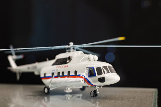 detailed scale model of a Mi-8 helicopter, a well-known Russian utility helicopter. The model is predominantly white, with a tricolor stripe (blue, white, and red) running along the fuselage