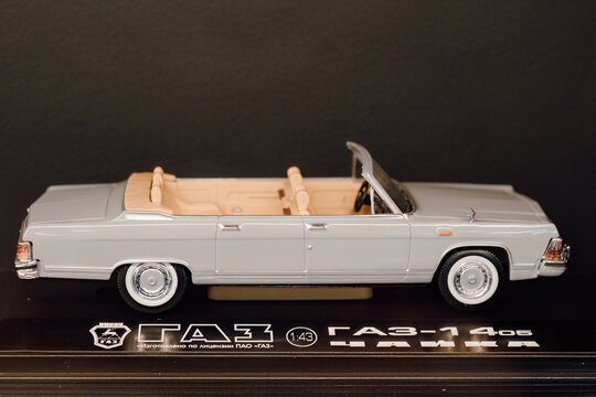 scale model of the GAZ-14 Chaika convertible car in a 1:43 scale. The model is presented against a dark background
