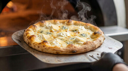 Freshly baked Classic Italian vegetarian cheese pizza coming out of oven: Hot Quattro Formaggi pizza on metal peel with steam